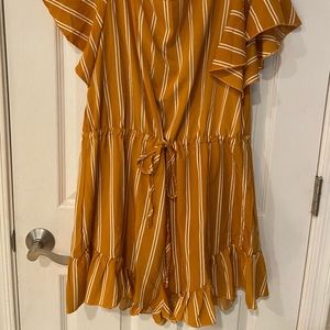Mustard yellow romper! Cute back tie, light material. NEVER WORN!